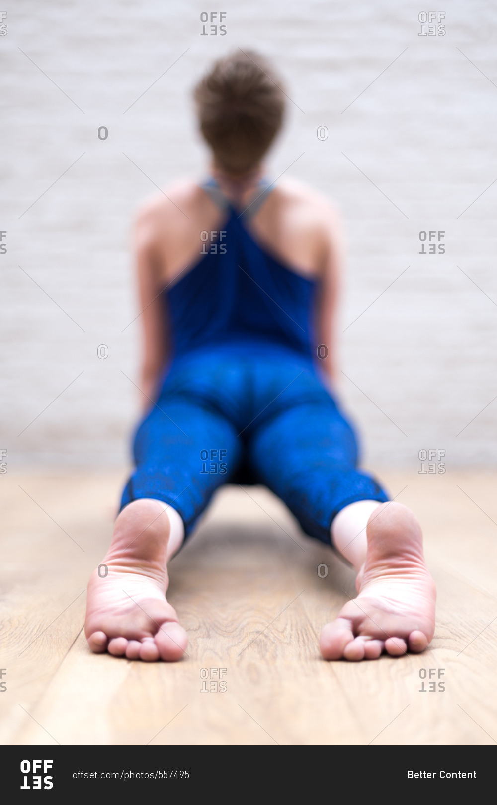 Young woman doing yoga with her feet in focus