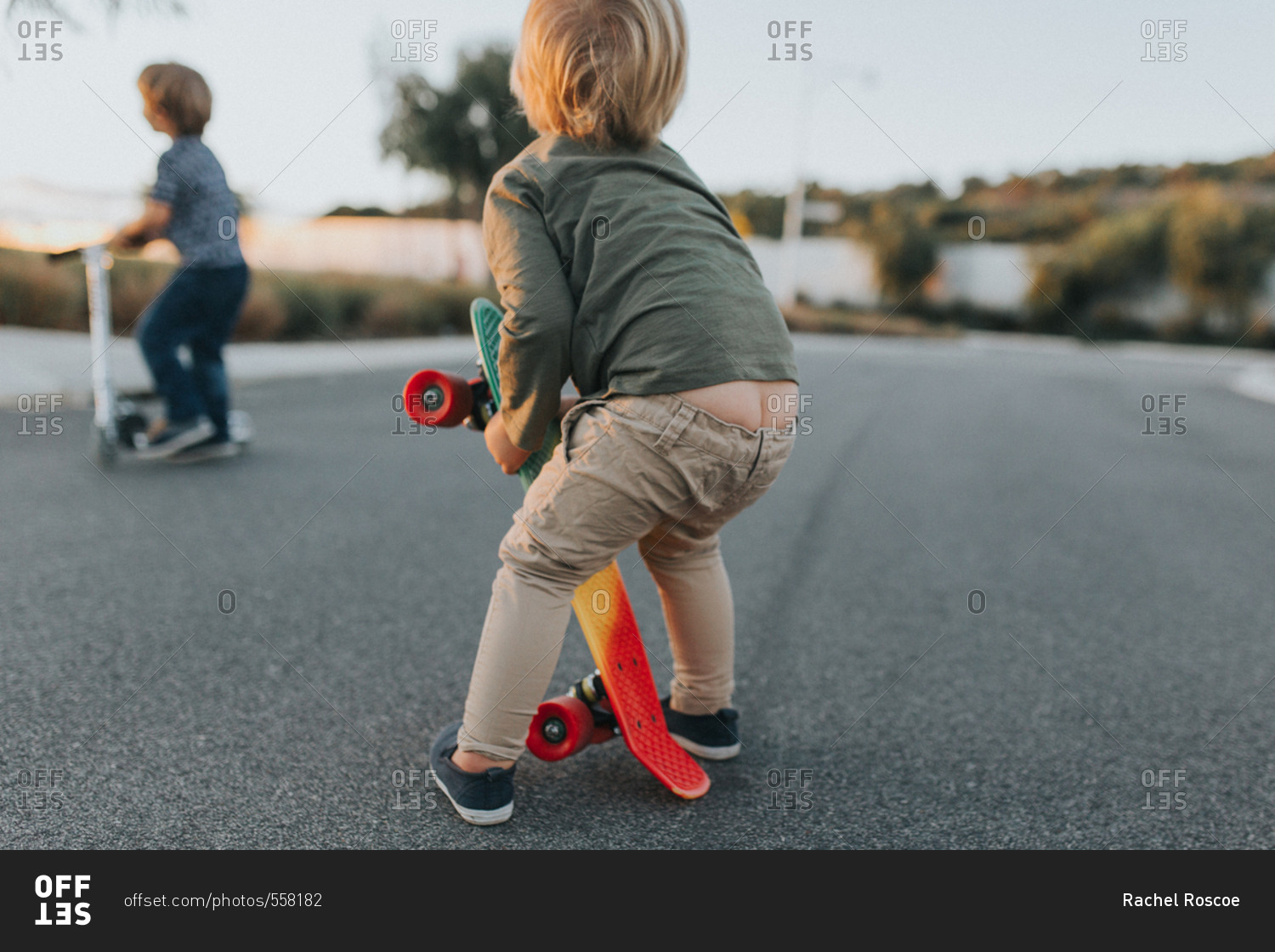 Toddler boy with pants falling down stock photo - OFFSET