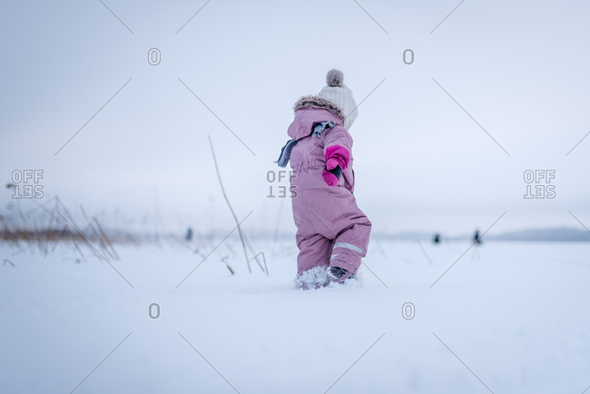 Girl walking on frozen lake