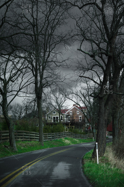 Storm clouds over a home on winding road in Ohio