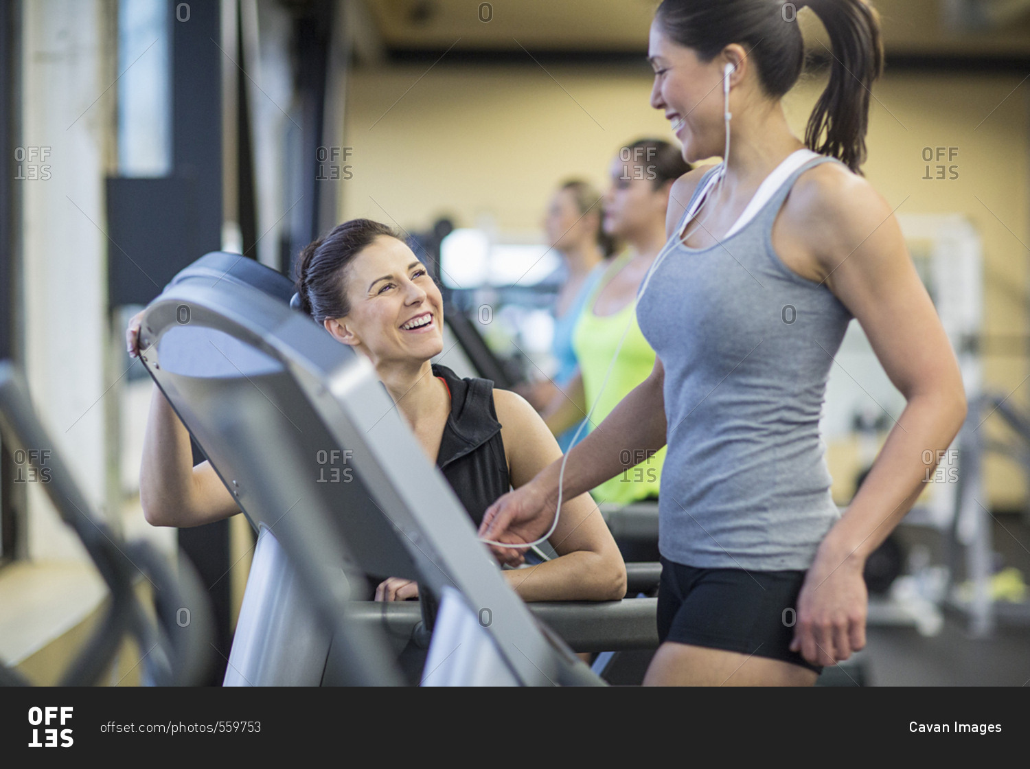 Instructor Talking To Woman Exercising On Treadmill In Gym Stock Photo Offset