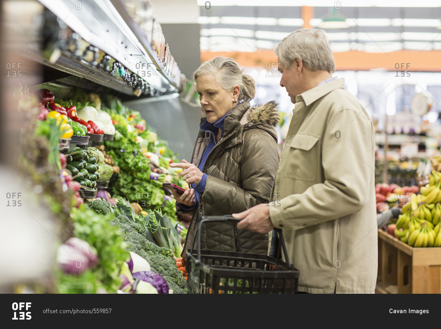 Senior couple shopping for vegetables at supermarket