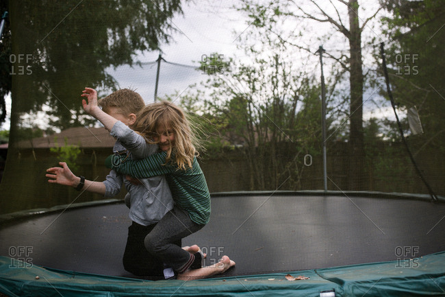 Boys wrestling on a trampoline