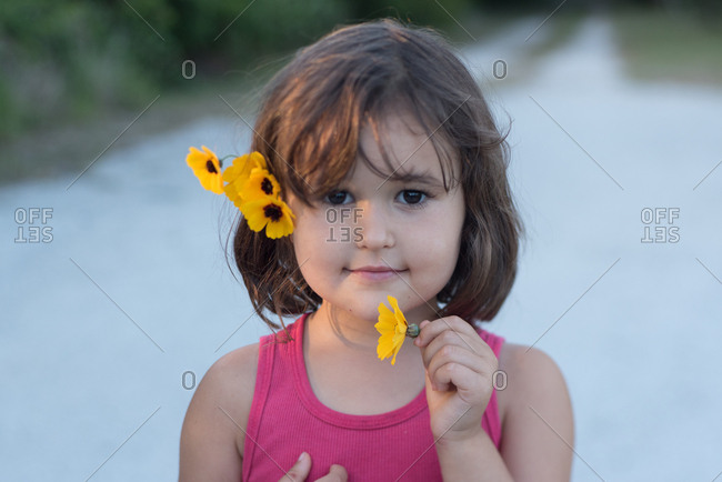 Portrait of a little girl with yellow flowers in her hair