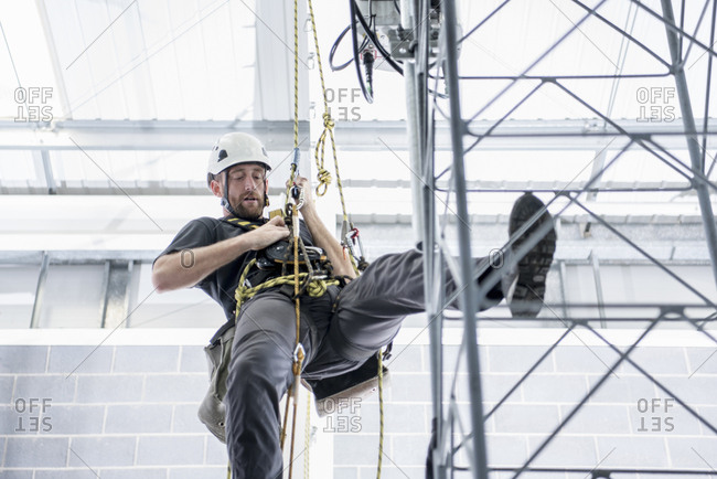 Transmission tower engineer training to climb in training facility