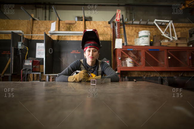 Portrait of female metalsmith at workshop bench