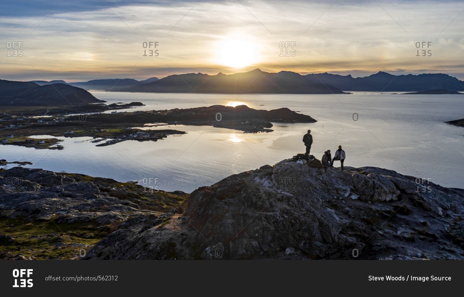 Aerial view of group of people climbing a summit on Kvaloya Island in autumn, Arctic Norway