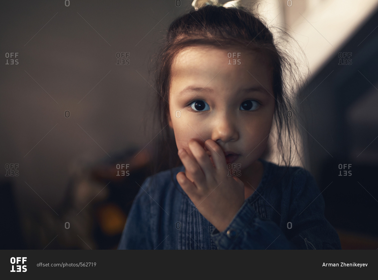 Cute girl scratching her cheek with a puzzled look