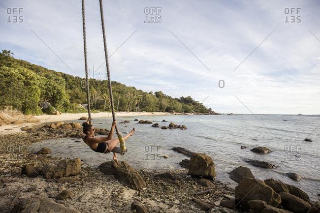 Thailand- Surat Thani- Ko Pha Ngan- woman on swing at Secret Beach
