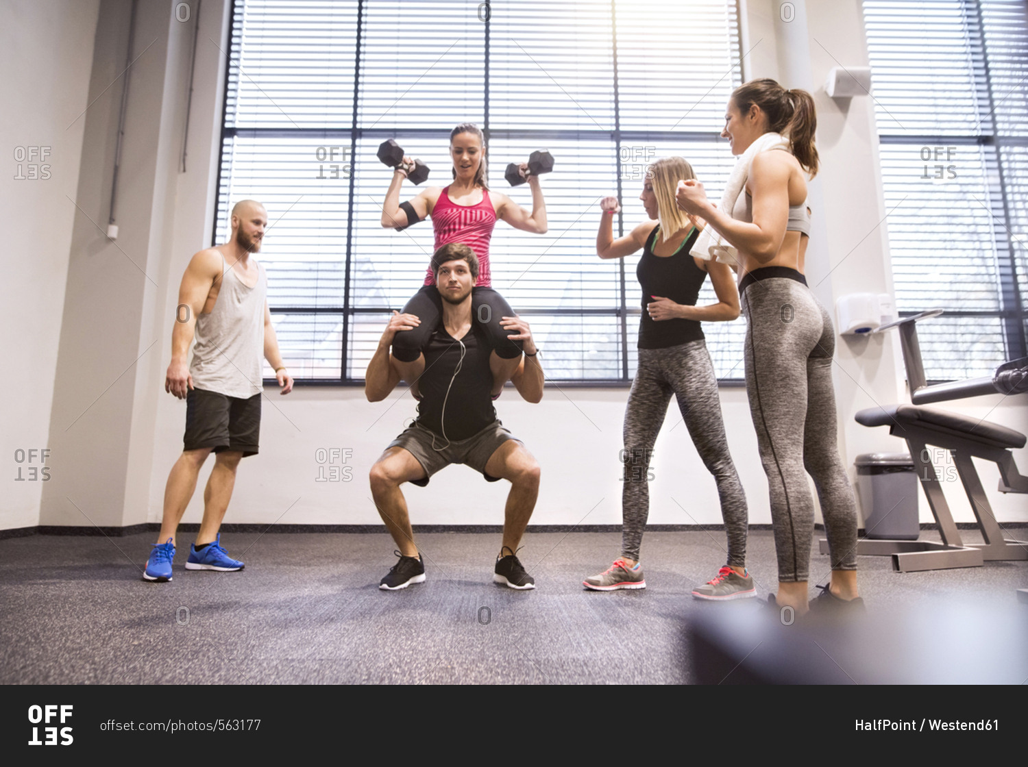 Young people doing fitness training in gym- lifting partners stock ...