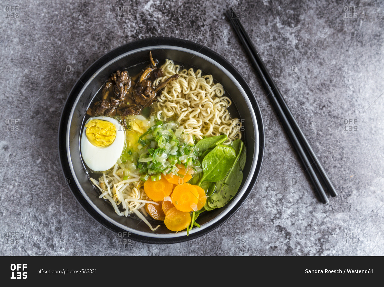 Bowl of ramen soup with spinach- carrot- boiled egg- bamboo sprouts and mushrooms