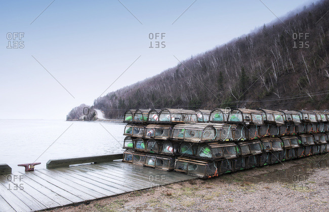 Lobster traps stacked in parking lot/dock along the Cabot Trail, Nova Scotia, Canada
