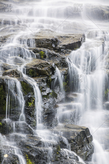 Detail of water cascading down dark rock on Bridalveil Falls in Keystone Canyon, South-central Alaska, Valdez, Alaska, United States of America