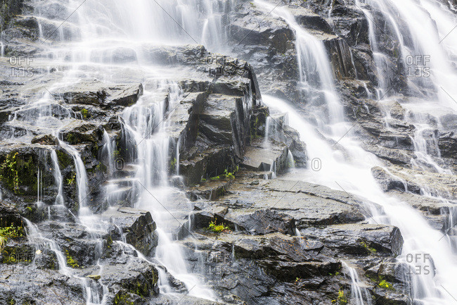Detail of water cascading down dark rock on Bridalveil Falls in Keystone Canyon, South-central Alaska, Valdez, Alaska, United States of America