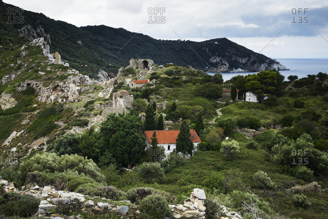 Houses on a rugged landscape on a greek island along the Aegean sea, Skiathos, Greece