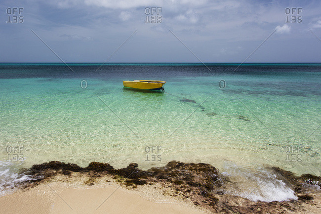 A lone boat in the turquoise water off a tropical island, Frederiksted, St. Croix, Virgin Islands, United States of America
