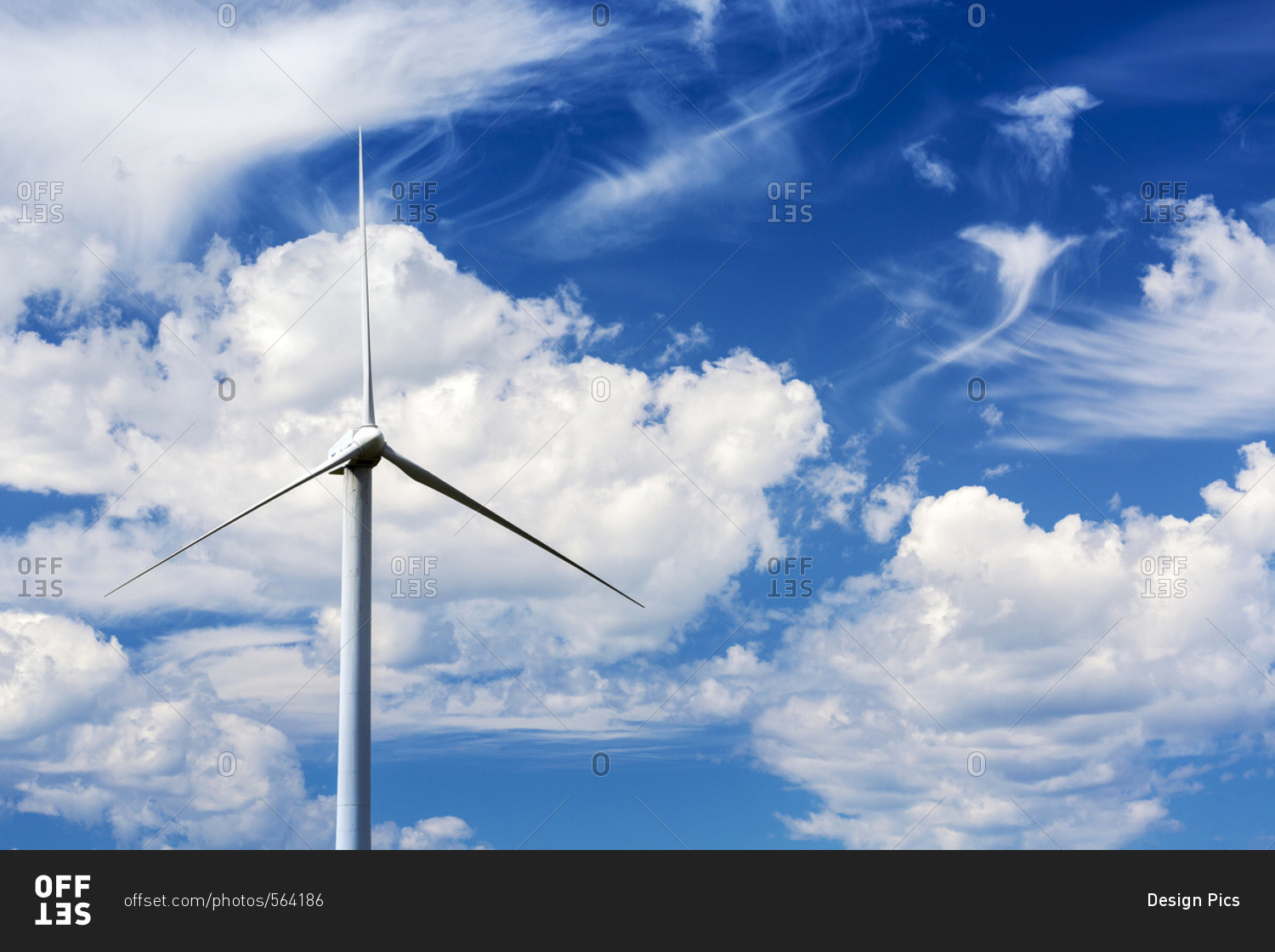 Close up of a large wind mill's blades with clouds and blue sky, North of Glenwood, Alberta, Canada