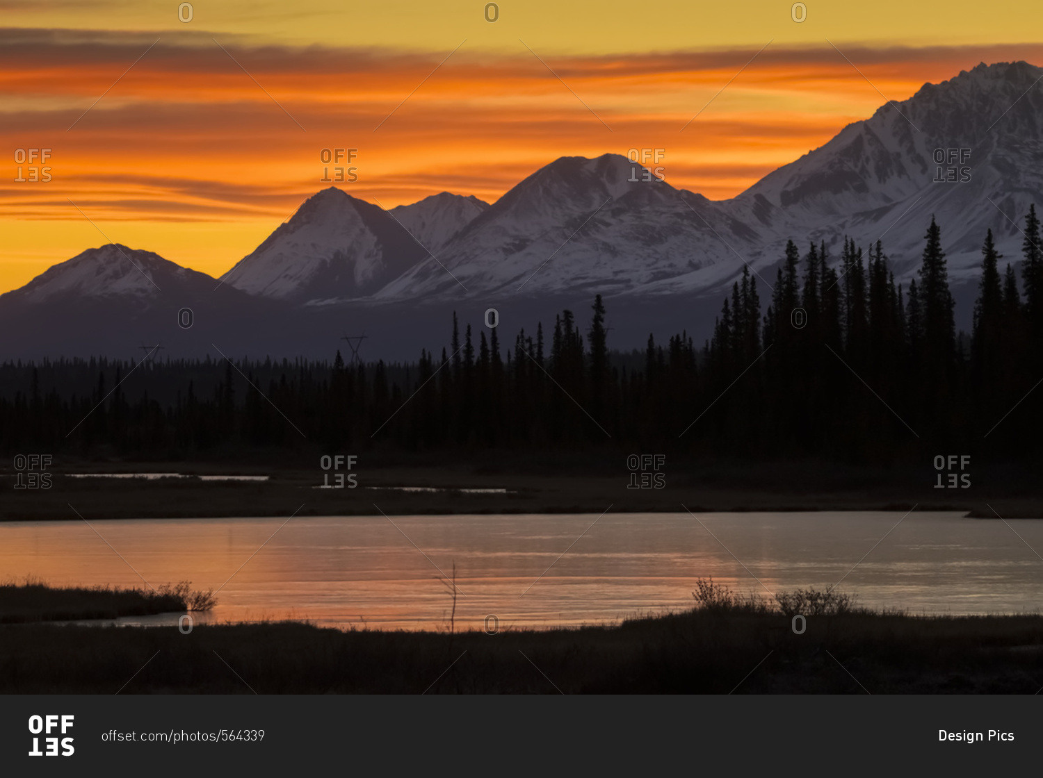 Sunrise over the pond and mountains along the Parks Highway in autumn, near Cantwell in interior Alaska, Alaska, United States of America