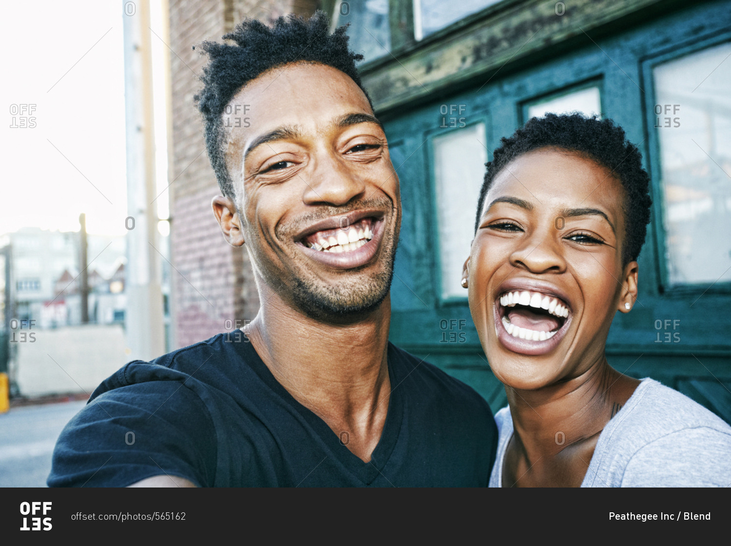 Portrait of smiling Black couple in city