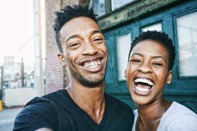 Portrait of smiling Black couple in city
