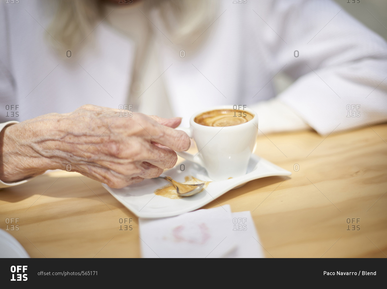 Hand of older Caucasian woman drinking coffee