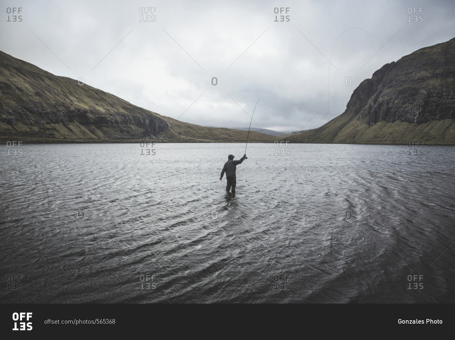 Mykines, Faroe Islands - May 10, 2016. A person is fishing in a lake at the Faroe Islands.