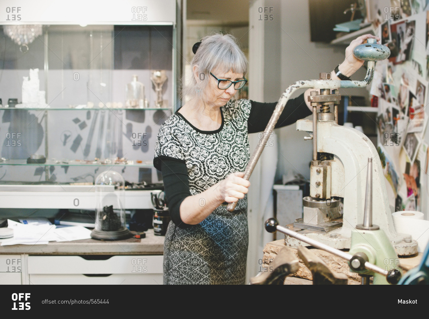 Senior woman working on vise grip in workshop