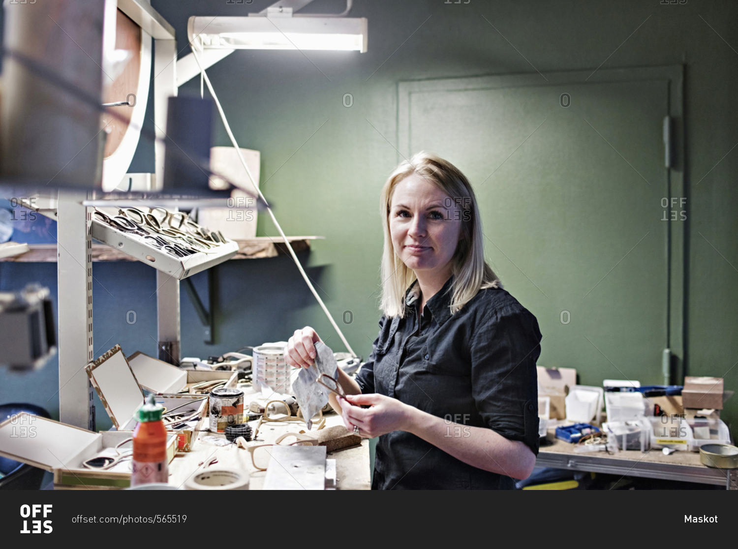 Portrait of confident female owner standing at eyeglasses stock photo OFFSET