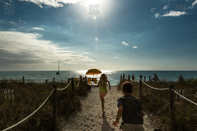 Captiva Island, Florida, USA - March 27, 2017: Two children running towards the ocean