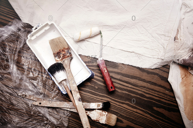 Still life of paint brushes and paint roller, overhead view