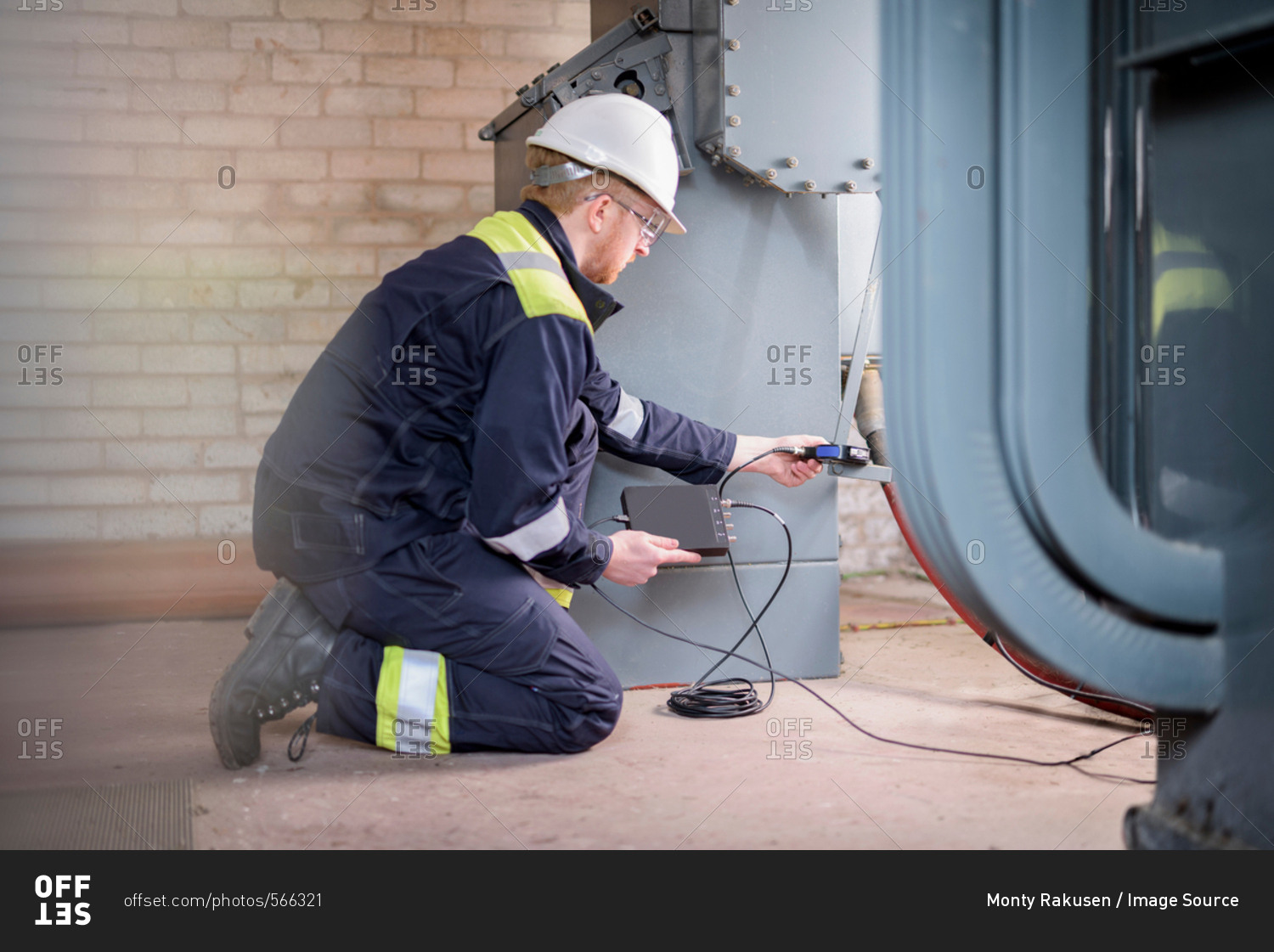 Worker testing transformers in electricity substation