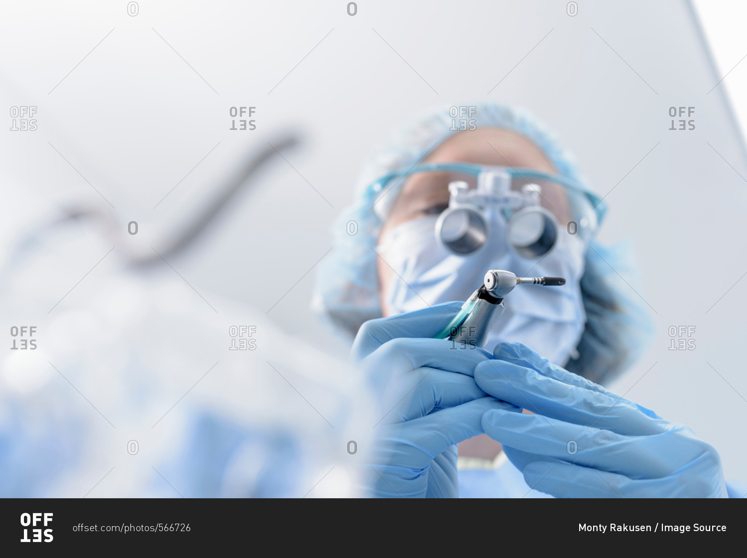 Dentist preparing dental implant in dental surgery