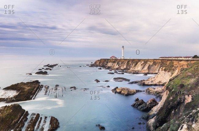 Sea with light house in distant background, Point Arena, California, US