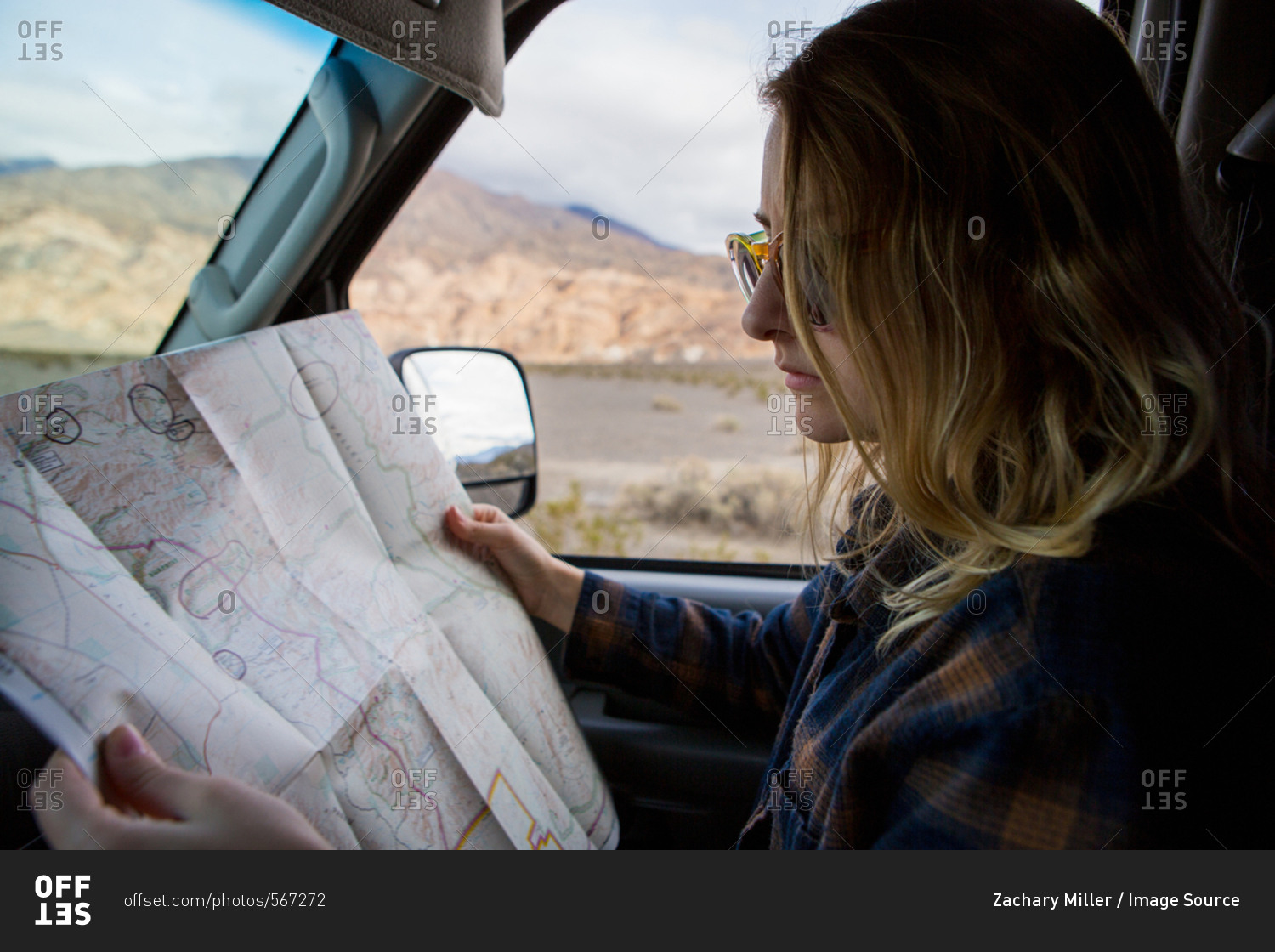 Woman reading map in car, Death Valley National Park, California, US