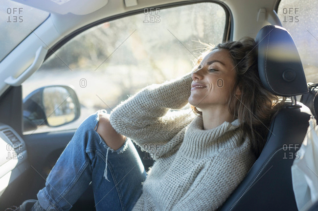 Woman reclining in car front seat
