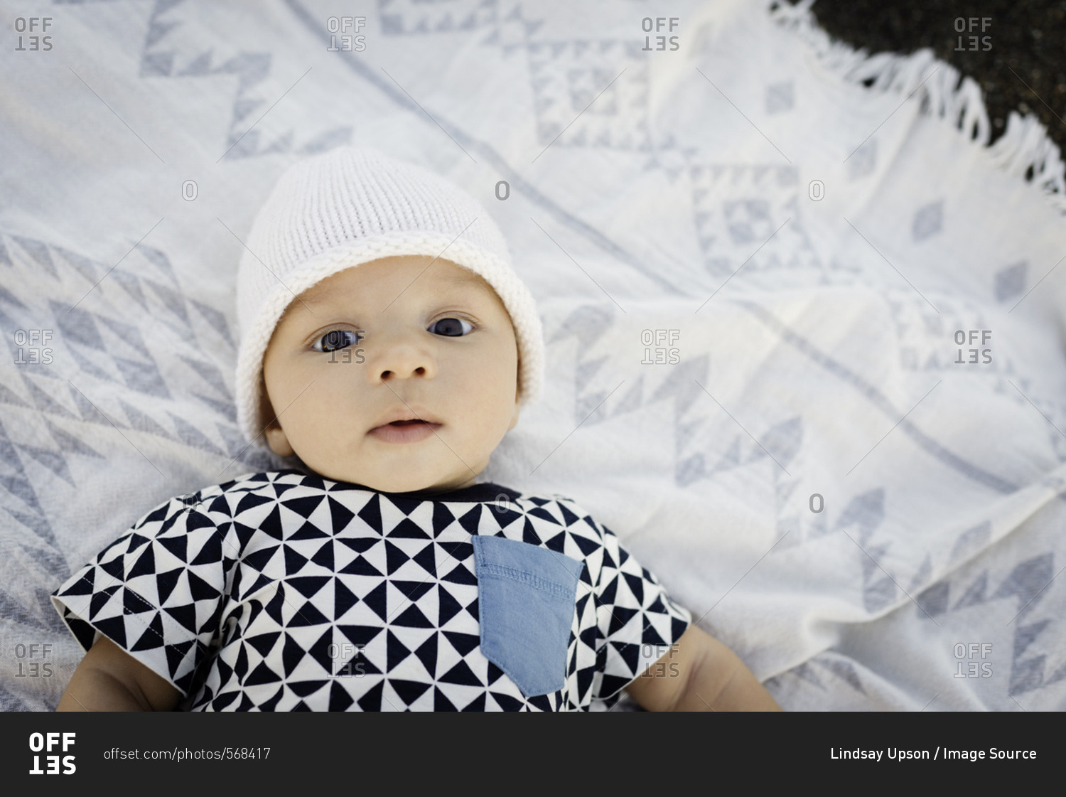 Portrait of baby boy lying on blanket, overhead view stock photo OFFSET