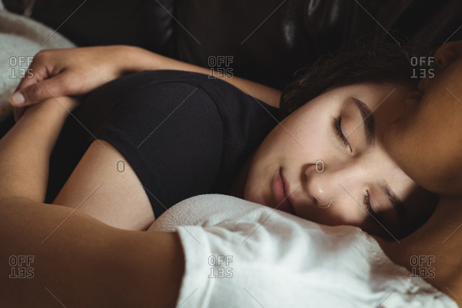 Close up of lesbian couple sleeping together on couch