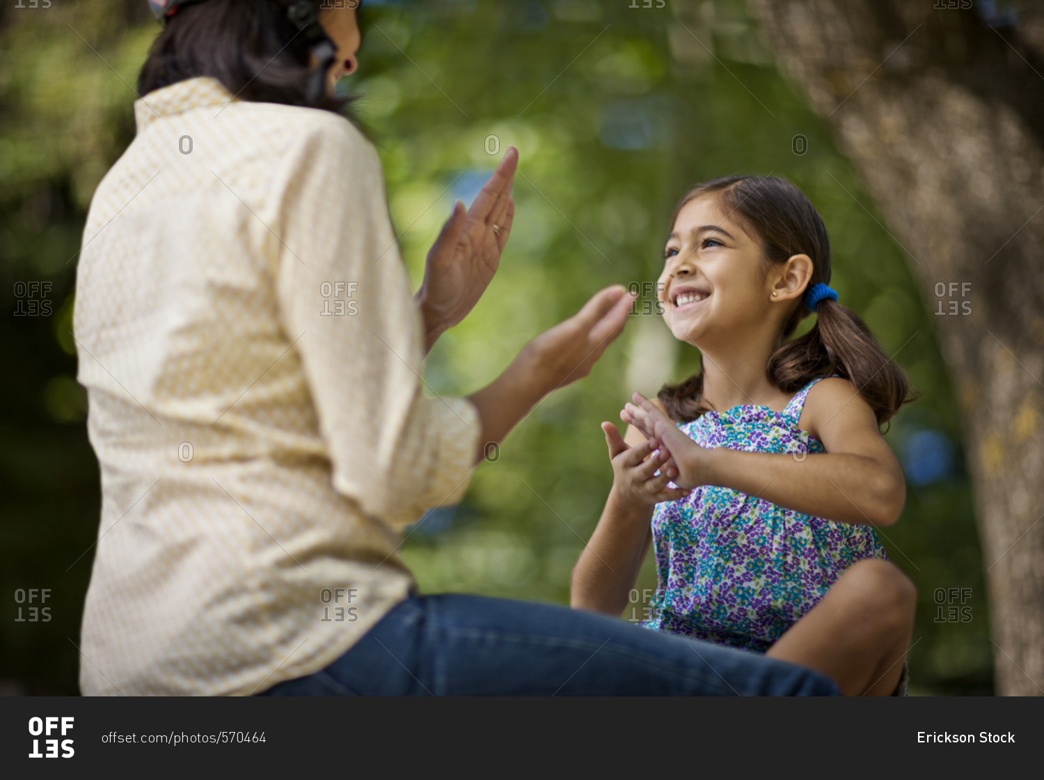 Girl playing a clapping game with her mother
