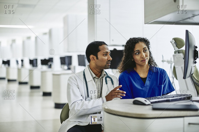 Doctor and nurse working at computer in medical lab