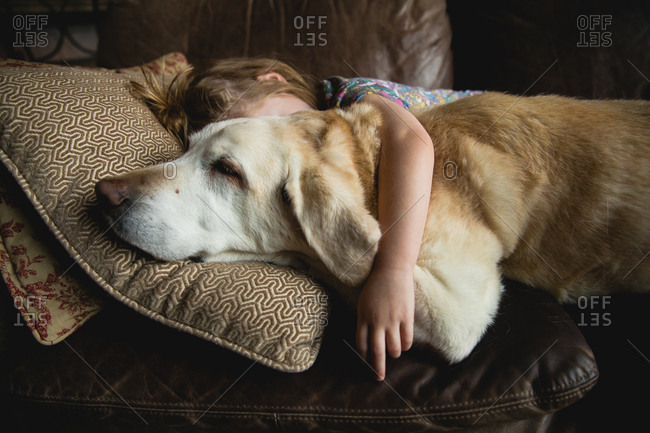 Sleeping girl with arm around her dog