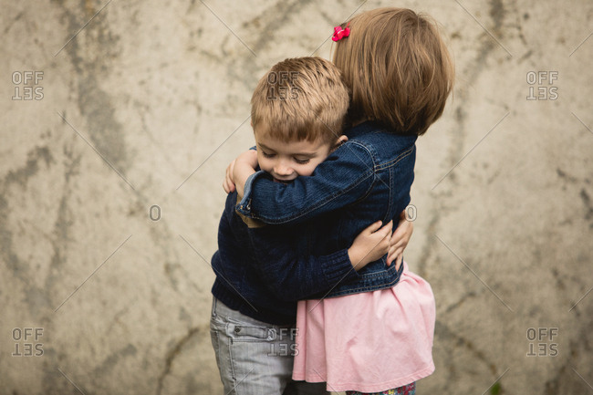 brother and sister hugging