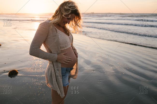 Pregnant woman in coastal sunset