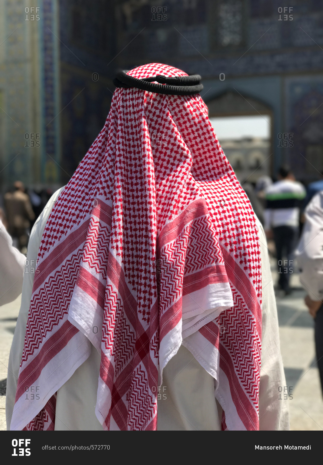 Muslim man back wearing Arabic traditional fashion stock photo - OFFSET