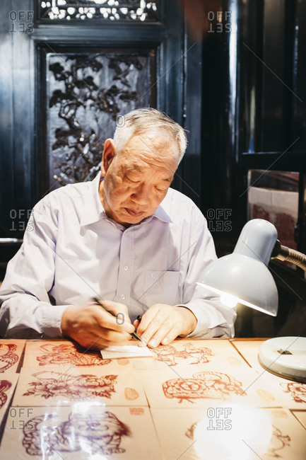 Guangzhou, China - April 29, 17: Asian senior man with Chinese paper-cut