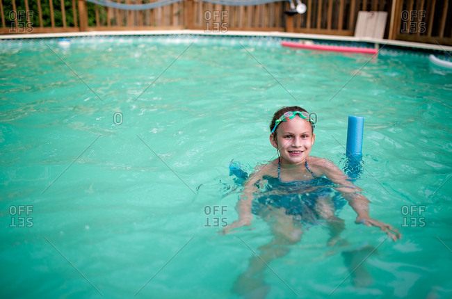 Girl on a noodle in the pool