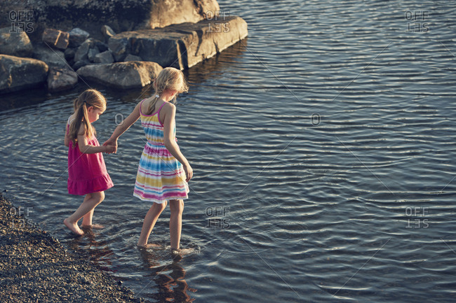 Girls Wading In Lake Stock Photo Offset