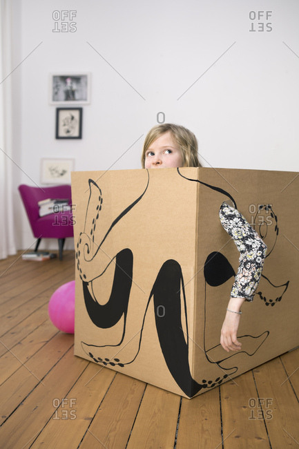 Girl inside a cardboard box painted with an octopus