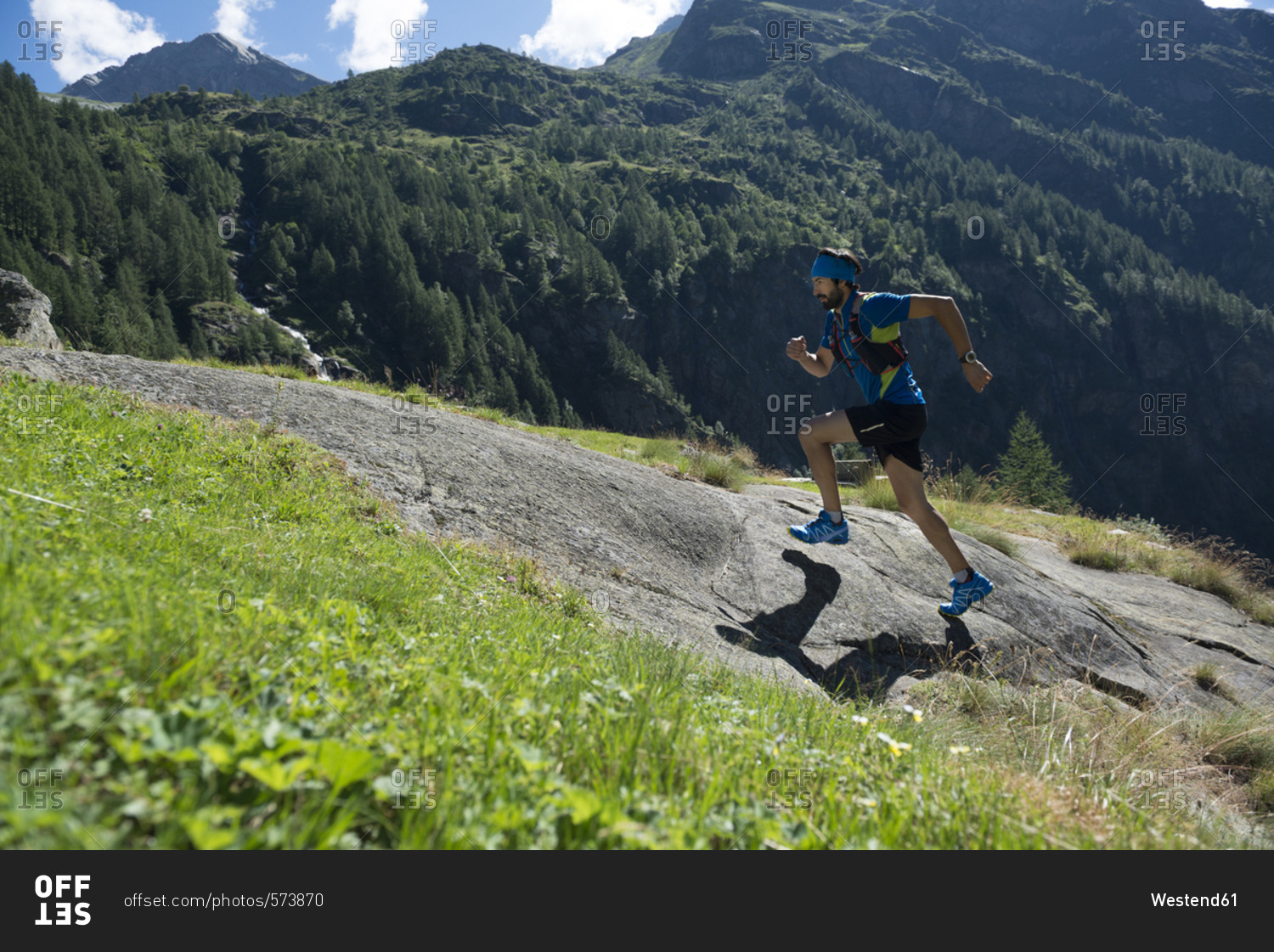 Italy- Alagna- trail runner on the move near Monte Rosa mountain massif