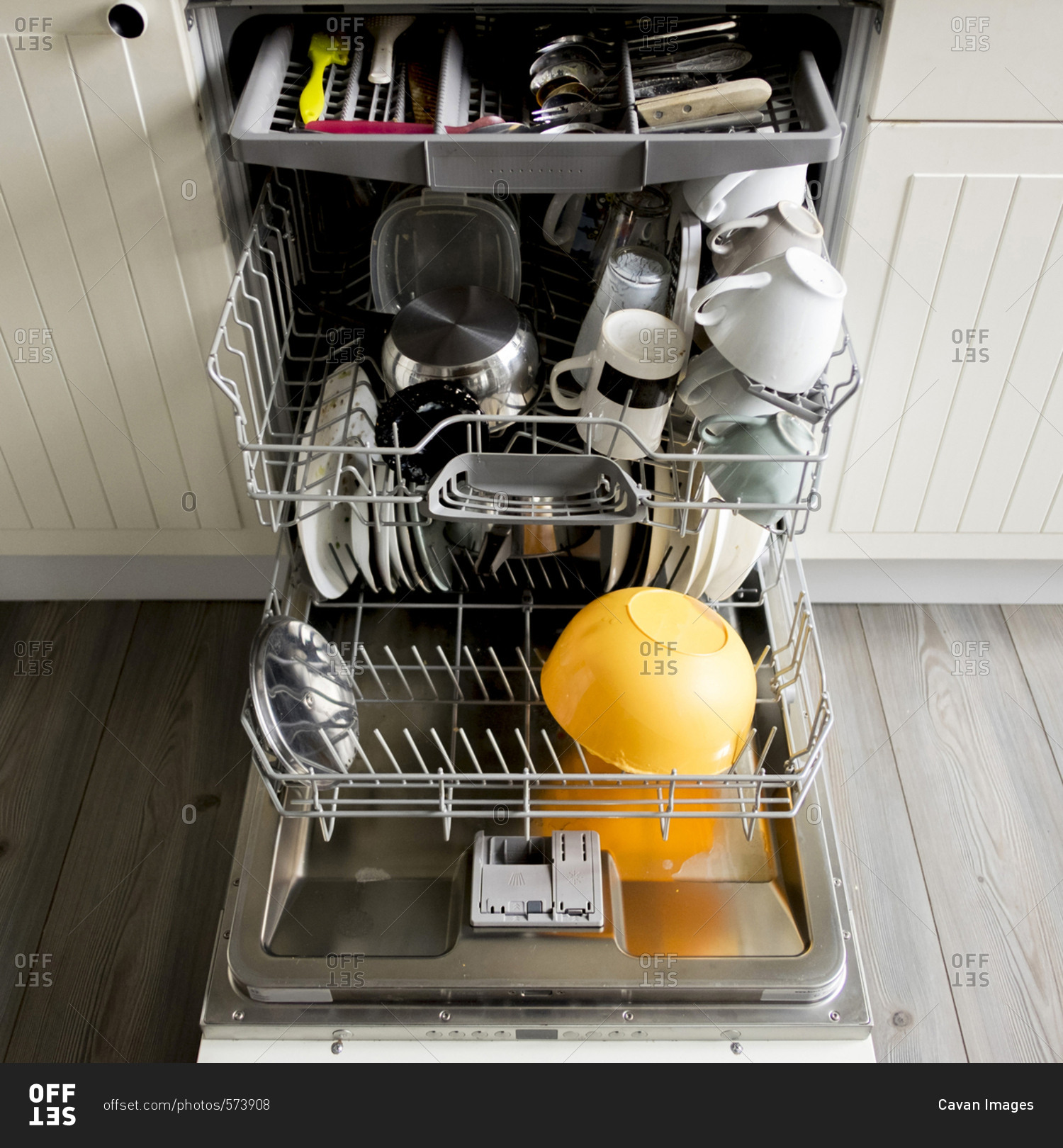 High angle view of utensils in dishwasher at kitchen stock photo OFFSET