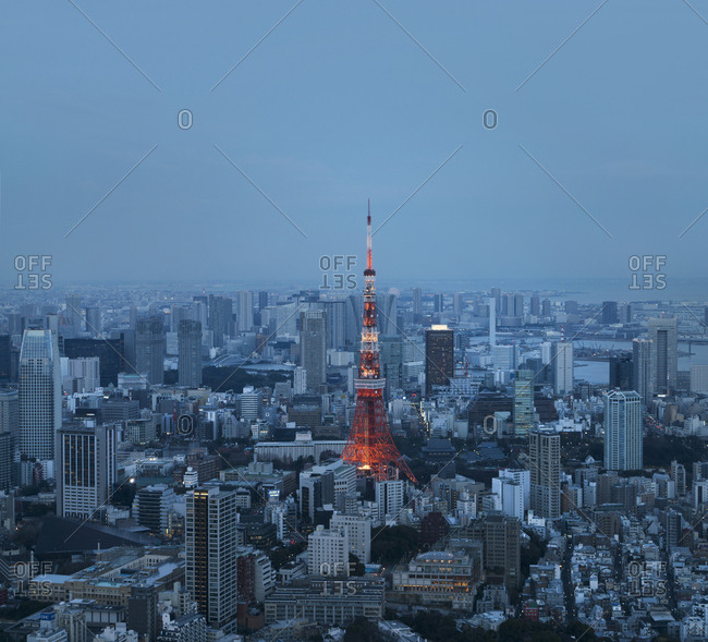 Aerial view of illuminated Tokyo Tower amidst cityscape at dusk